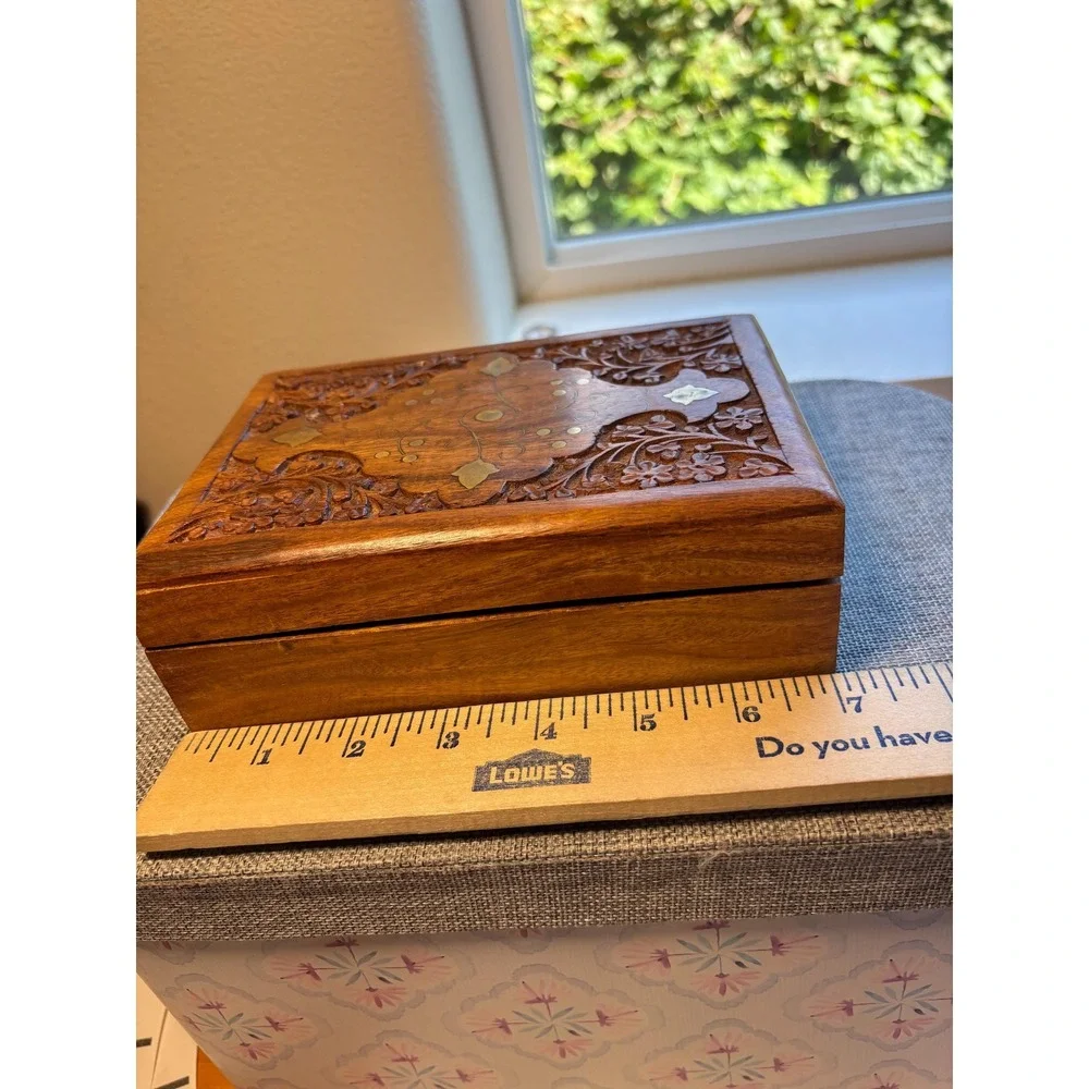 Handmade wooden jewelry box with a brass inlay and hand-carved floral design